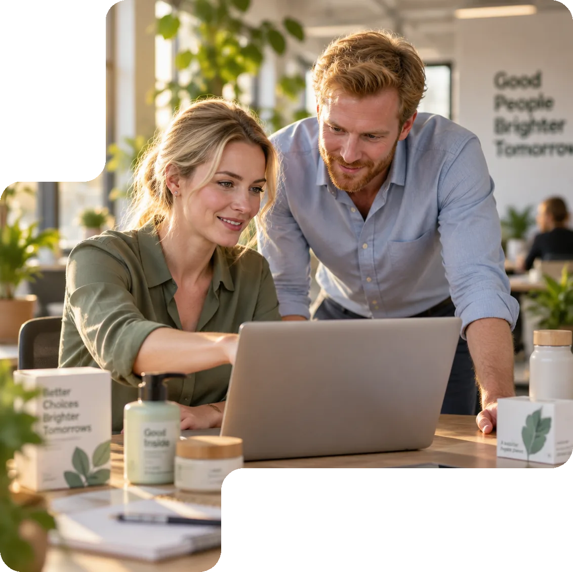 Two colleagues reviewing product data for sales channels together on a laptop